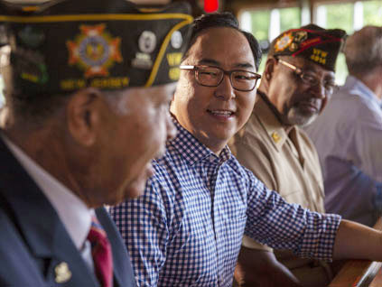 Andy Kim talks with a group of veterans