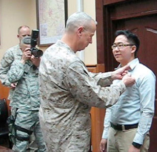 Andy Kim receiving honors for his foreign service